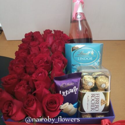 BOX OF GOODIES AND RED ROSES